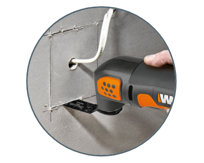 image of a person using the tool to cut a square hole into drywall