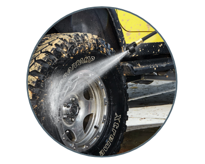 image of someone using the hydroshot to clean off a muddy tire