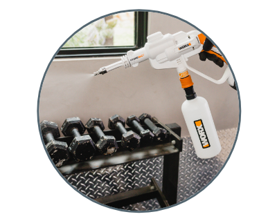 circle photo of worx disinfectant sprayer being used to sanitize dumbbell weights