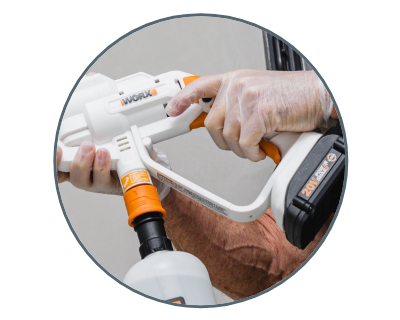 circle photo close up view of person holding worx sanitizing and disinfectant sprayer