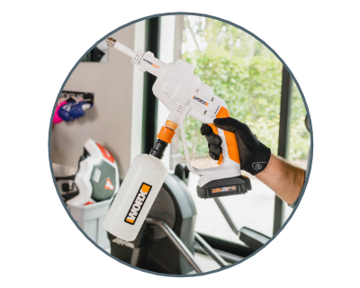 circle photo of person pulling trigger on worx hydroshot disinfectant sprayer