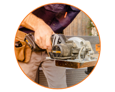 image of a man using the saw on a 2 by 4