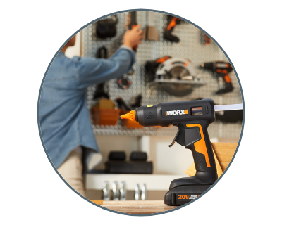 person using the glue gun in the garage