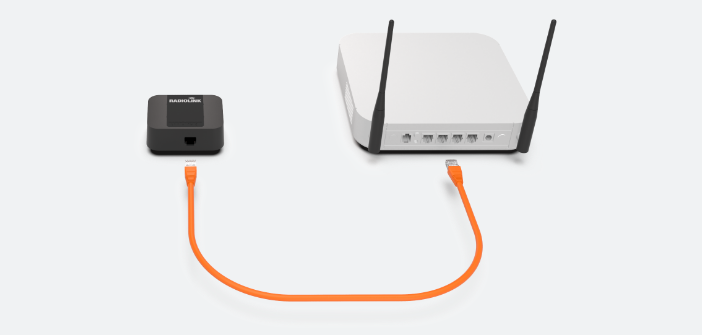 a radio link installed to a router with an orange cable