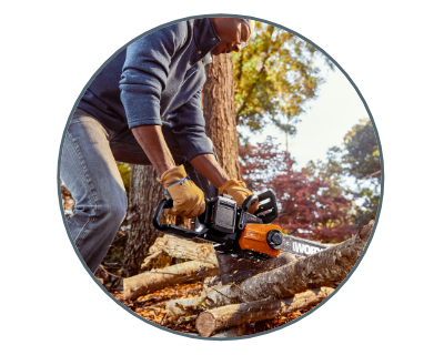 image of a man using the chain saw to cut logs on the ground