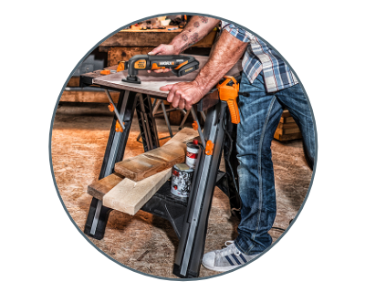 man sanding a piece of wood laid on the pegasus